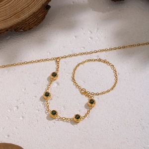 Dettaglio macro della catena in oro 18K con cinque zirconi verdi in stile vintage