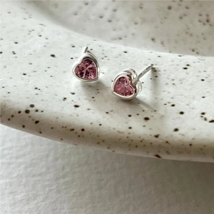 Pink heart-shaped zircon earrings in S925 sterling silver on a light ceramic plate