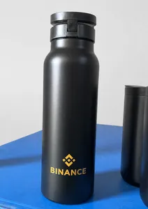 Detail of matte black stainless steel sports bottle with magnetic lid and gold logo