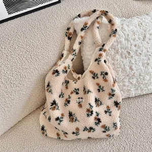 Detailed texture of off-white plush tote bag with brown floral patterns and ozakka label