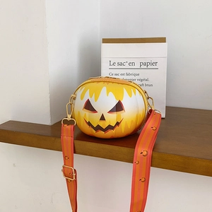 Detail of Jack-o'-lantern pumpkin round crossbody bag with striped strap on a shelf