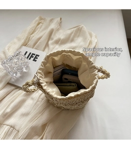 Internal view of beige woven bucket bag showing spacious storage for phone and wallet