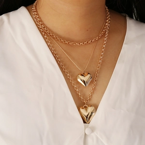 Elegant gold-tone multi-layered heart necklace for women, stylish heart pendants on model