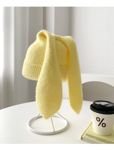 Detailed macro shot of the fluffy yellow knit hat featuring long bunny ears texture
