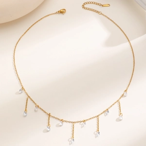 Detail of 18k gold plated stainless steel necklace with sparkling zircon tassels