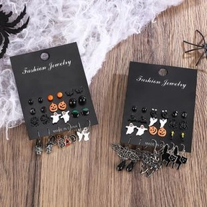 Detailed close-up of festive Halloween earring set with pumpkin and ghost motifs