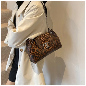 Detailed close-up of the elegant leopard print bag with a metallic T-buckle closure