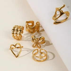 Set of six vintage 18k gold plated stainless steel rings featuring butterfly and heart shapes