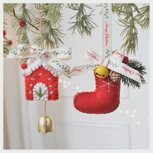 Felt Christmas ornaments featuring small house and red boot shapes on pine branches