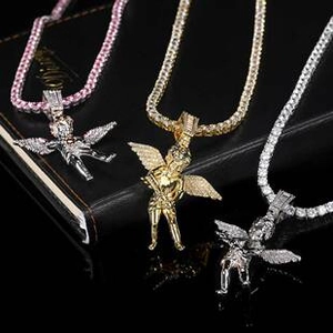 Three hip-hop angel pendants in gold, silver and rose gold with tennis chains on black base