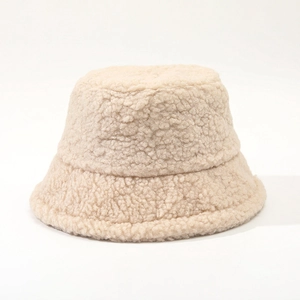 Detailed macro shot of the soft beige lambskin wool texture on a warm winter bucket hat