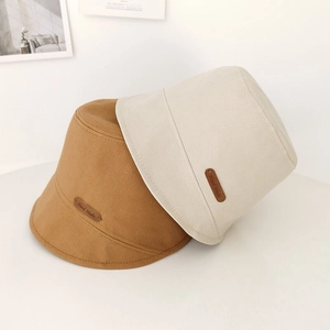 Japanese style canvas bucket hat in brown and beige colors with handmade leather patch