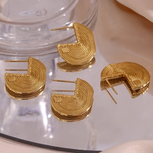 Macro shot of 18K gold plated U-shaped earrings with twisted rope texture detail