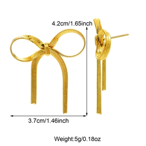 Detailed view of golden bow earrings with snake chain texture and size dimensions