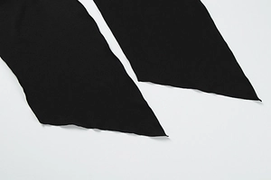 Detail of sexy asymmetric hemline on black slim fit strapless dress made of woven fabric