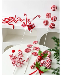 Close-up of red and white striped Christmas tree picks with candy canes and ornaments