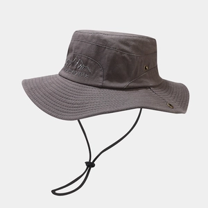 Detail of dark grey camo sun hat featuring peak embroidery and adjustable windproof rope
