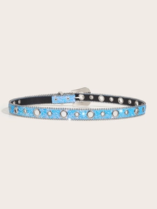 Close-up of sky blue glitter belt with silver eyelets and studded edges in Y2K punk style
