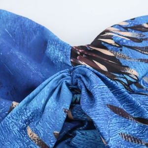 Women's resort style two-piece set featuring blue fabric with leaf patterns and texture