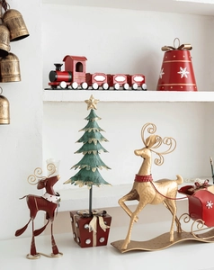 Detail of red metal Christmas train and golden deer sleigh holiday decorations