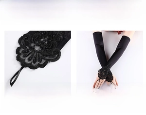 Detail of long black fingerless bridal gloves with floral lace, sequins and beadwork