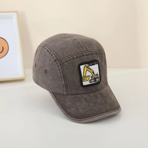 Detail of vintage washed brown kids baseball cap with yellow excavator embroidery patch