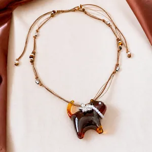 Artistic resin cat pendant necklace with pearl collar and elegant flower detail
