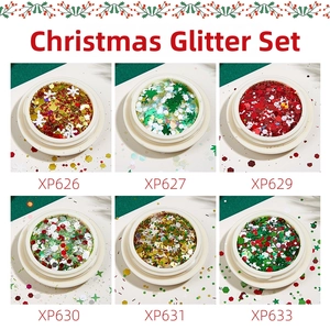 Detailed view of Christmas nail art glitter sets with snowflake and star shapes in cases