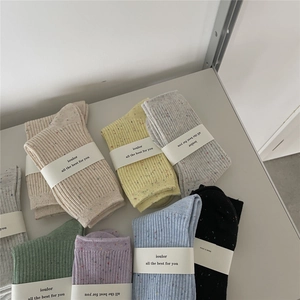 Detailed view of colorful confetti knit cotton crew socks in multiple vibrant color options