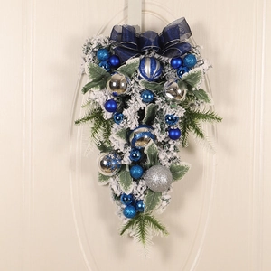 Blue and silver Christmas teardrop door swag with velvet bow and snowy pine needles