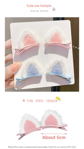 Detail of 5cm plush cat ear hair clips in pink and blue with retail card packaging