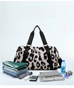 Detail view of large cow print travel bag with sturdy handles and adjustable strap