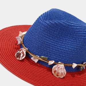 Straw sun hat with shell trim in navy and red contrast for beach vacation style