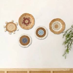 Detailed macro view of 5-piece set boho straw woven wall baskets with blue mandala patterns