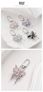 Close-up of alloy butterfly pendant with translucent wings and teardrop gem detail
