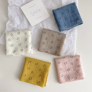 Five pack of breathable cotton gauze baby bibs with smiley faces in pastel colors
