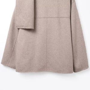 Macro shot of the camel wool coat back hem showing premium stitching and fabric texture