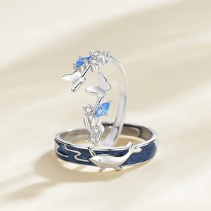 Silver whale and butterfly couple rings featuring blue gemstones and enamel details