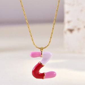 Detailed macro view of enamel letter Z pendant with pink purple and red mixed colors