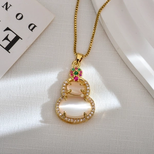 Detailed close-up of a gold-plated Wu Lou pendant necklace featuring cat-eye gemstones