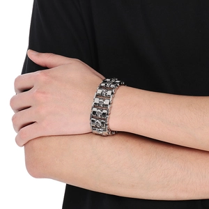 Close-up of men's punk skull chain bracelet in polished steel on a model's wrist