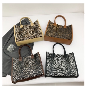 Flat lay of leopard print tote bags in four neutral colors for women fashion