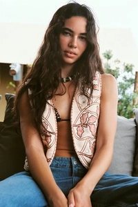 Detail view of a vintage floral embroidery vest in beige with pink flowers and open front