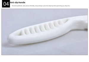 Close-up of the ergonomic non-slip handle on the white plastic pet grooming comb