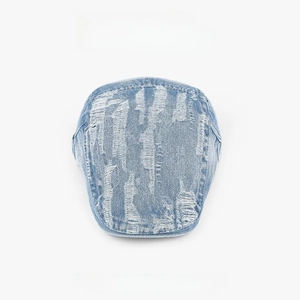 Detailed view of light blue denim flat cap featuring vintage distressed ripped holes