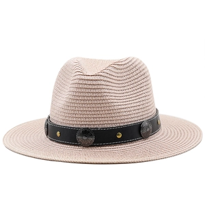Detail of Panama straw hat with black leather band featuring vintage metal studs