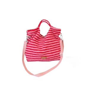 Pink and red striped plush shoulder bag with soft fleece texture and long strap