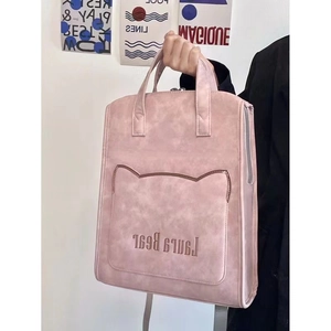 Detailed shot of pink PU leather backpack with cat ear flap and embroidery