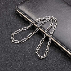 Polished silver stainless steel paperclip chain necklace with lobster clasp on black background