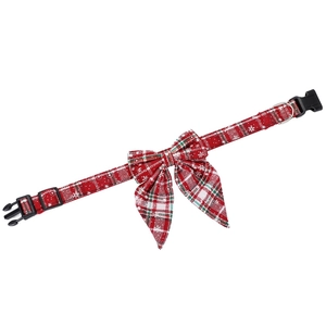Detail of red plaid Christmas dog collar with bow tie and adjustable plastic buckle